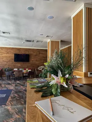 a lobby with a table with flowers on it at City Plaza in Botevgrad