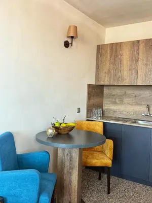 a kitchen with a table with a bowl of fruit on it at City Plaza in Botevgrad