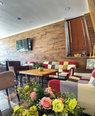 a restaurant with a table and chairs and flowers at City Plaza in Botevgrad