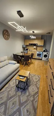 a living room with a couch and a table at Aspen Suites Luxury apartment A005 in Razlog