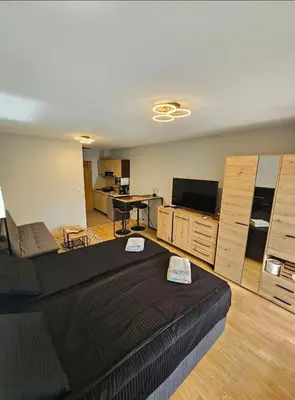 a living room with a large bed and a kitchen at Aspen Suites Luxury Studio A006 in Razlog
