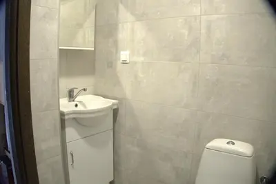 a white bathroom with a sink and a toilet at Panorama view free parking in Sofia