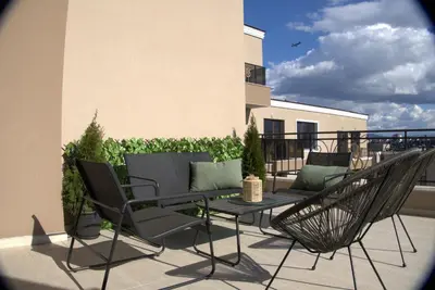 a patio with chairs and a table on a balcony at Panorama view free parking in Sofia