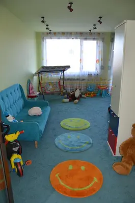 a living room with a blue couch and toys at Belvedere Holiday Club K106 in Bansko