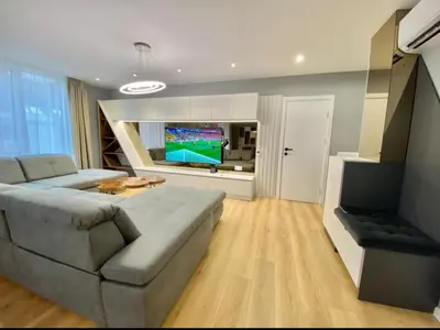 a living room with a couch and a flat screen tv at Gran Capital - Mountain View, FREE Parking in Sofia