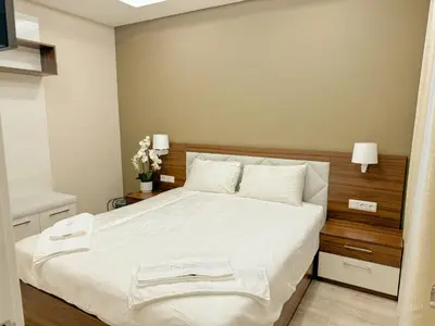 a bedroom with a large bed with white sheets at Luxury Apartments 1 in Sofia