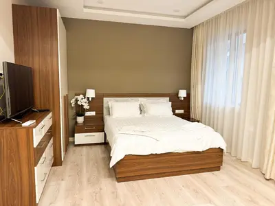 a bedroom with a bed and a flat screen tv at Luxury Apartments 1 in Sofia