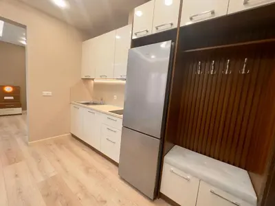 a kitchen with white cabinets and a refrigerator at Luxury Apartments 1 in Sofia