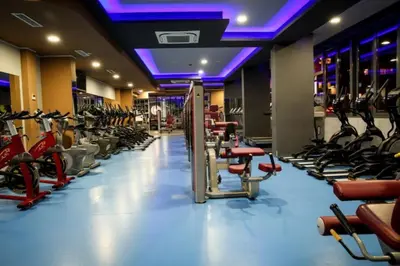 a gym with a lot of treadmills and exercise bikes at BOOK High Rise Studio by Cosher in Sofia