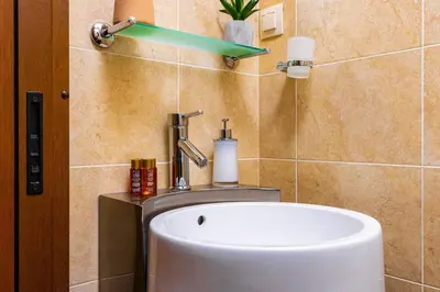 a bathroom with a sink and a toilet at Central Park Apartment Dragan Tsankov in Plovdiv