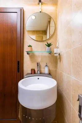 a bathroom with a white sink and a mirror at Central Park Apartment Dragan Tsankov in Plovdiv