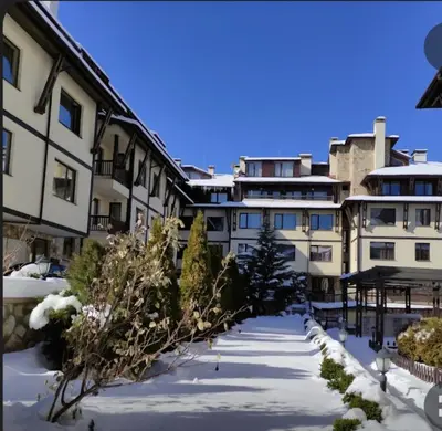 an apartment complex in the winter with snow on the ground at Guest Suite in Bansko