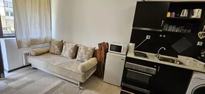 a living room with a couch in a kitchen at Guest Suite in Bansko
