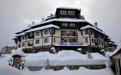 a large building covered in snow in front at Guest Suite in Bansko