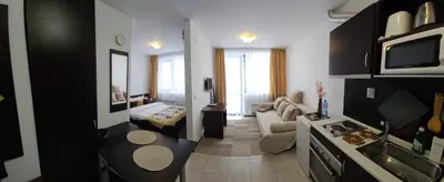 a living room with a kitchen and a living room with a couch at Guest Suite in Bansko