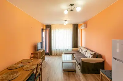 a living room with a couch and a table at Relax Apartment in Sofia
