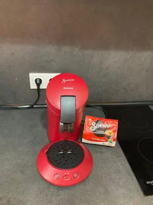 a red blender sitting on a counter next to a box at Relax Apartment in Sofia