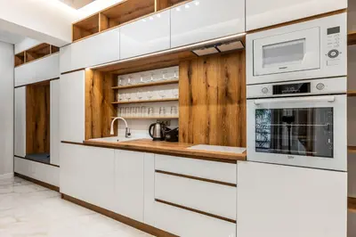a kitchen with white appliances and wooden cabinets at Vitoshka Luxury 2-BR Retreat in Sofia