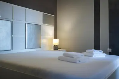 a bedroom with a bed with towels on it at Dias in Sandanski