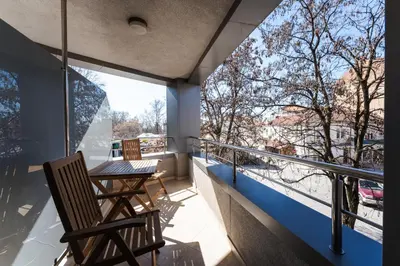 a balcony with two chairs and a table with a view at Dias in Sandanski