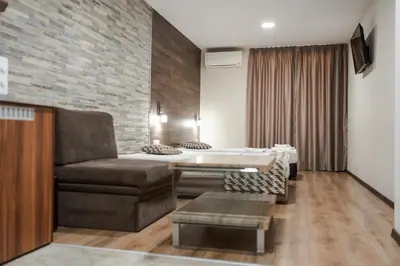 a living room with a couch and a bed at Dias in Sandanski