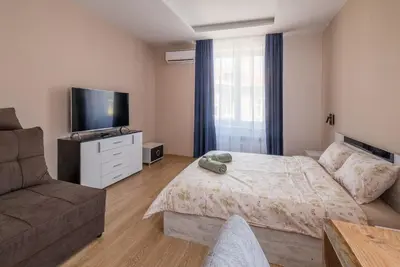 a bedroom with a bed and a tv and a couch at 3BDR, Top Center Retreat, Sofia Heart, FREE Parking in Sofia