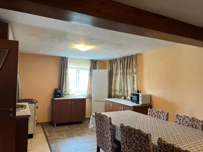 a kitchen with a table and chairs in a room at Villa Garden in Kremen