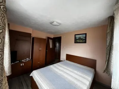a small bedroom with a bed and wooden cabinets at Villa Garden in Kremen