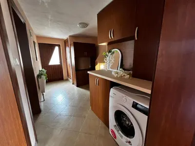 a small kitchen with a washing machine in it at Villa Garden in Kremen