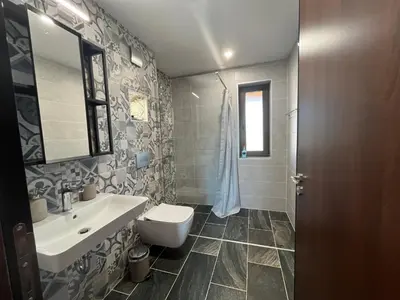 a bathroom with a sink and a toilet at Edelweiss Oreshak in Oreshak