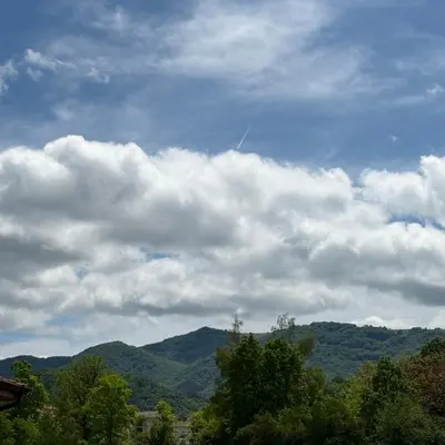 a kite flying in the sky over the mountains at Edelweiss Oreshak in Oreshak