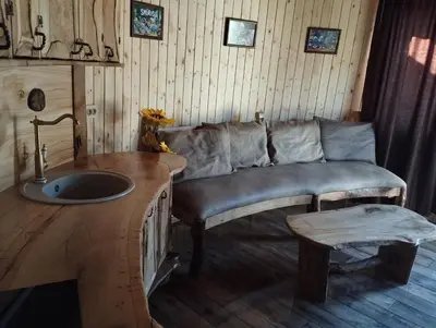 a living room with a couch and a sink at Приказната къщичка на Смърфовете in Krayni Dol