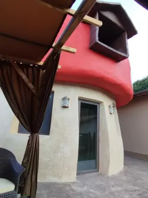 a house shaped like a dog house with a window at Приказната къщичка на Смърфовете in Krayni Dol