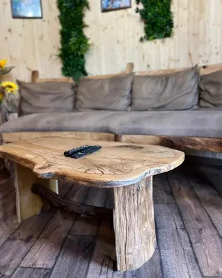 a wooden coffee table with a remote control on top at Приказната къщичка на Смърфовете in Krayni Dol