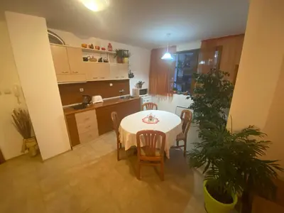 a kitchen and dining room with a table and chairs at Nevena Apartments in Bansko