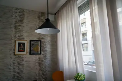 a room with a window and a pendant light at Aristocratic apartment with a parking spot in Sofia