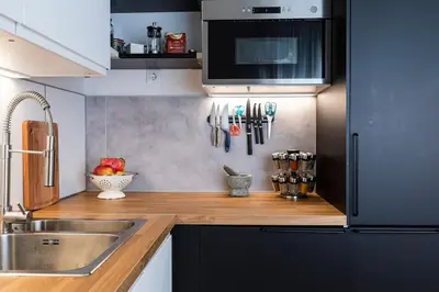 a kitchen with a sink and a counter with utensils at Aristocratic apartment with a parking spot in Sofia