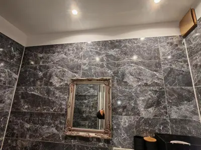 a bathroom with a mirror on a wall at Apartament 87 in Sofia