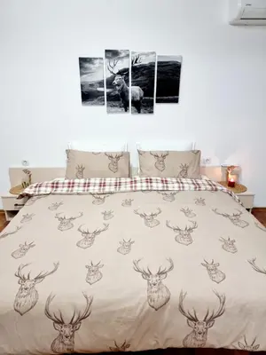a bedroom with a bed with deer heads on it at Studio Vihren 11,Bansko in Bansko