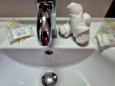 a bathroom sink with towels and a faucet at Studio Vihren 11,Bansko in Bansko