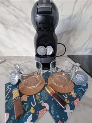 a coffee maker with two glasses on a table at Studio Vihren 11,Bansko in Bansko