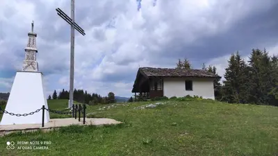 a small chapel and a cross on a hill at Panorama Stoykite Belvedere in Stoykite