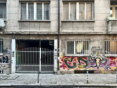 a building with graffiti on the side of it at Nostalgic '90s Place Historical Center in Sofia