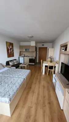 a bedroom with a bed and a kitchen and a table at Aspen Golf Resort and SPA, Studio J006 in Bansko