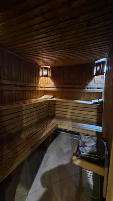 a empty wooden sauna with a bench in it at Aspen Golf Resort and SPA, Studio J006 in Bansko