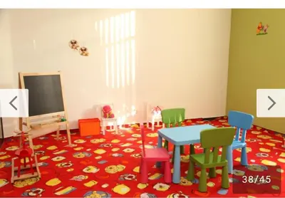 a room with a table and chairs on a rug at Aspen Golf Resort and SPA, Studio J006 in Bansko