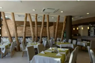 a dining room with white tables and white chairs at Aspen Golf Resort and SPA, Studio J006 in Bansko