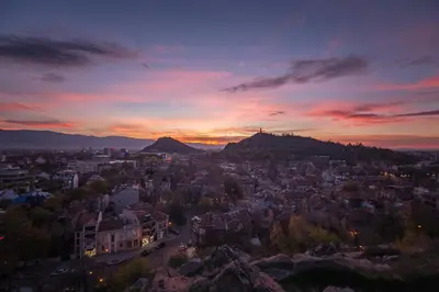 a view of a city at sunset at Modern 1BR Apartment with Free Street Parking and free Gym Pass in Plovdiv