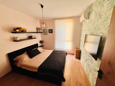 a bedroom with a bed and a window at Raya apartment in Plovdiv