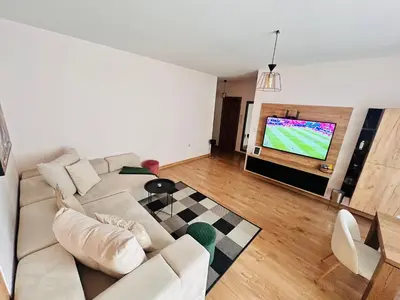 a living room with a couch and a tv at Raya apartment in Plovdiv